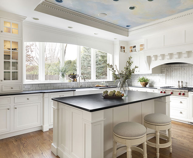 Stately kitchen remodel with large island, white cabinets, and painted ceiling