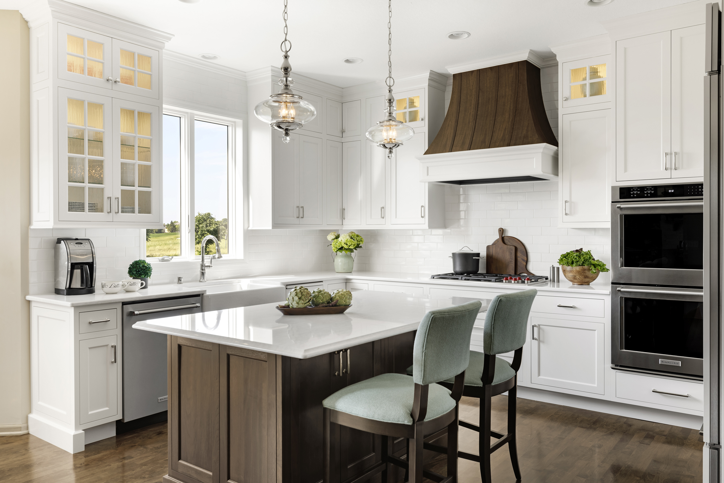 Transitional kitchen remodel with white cabinets and wooden island and custom hood vent