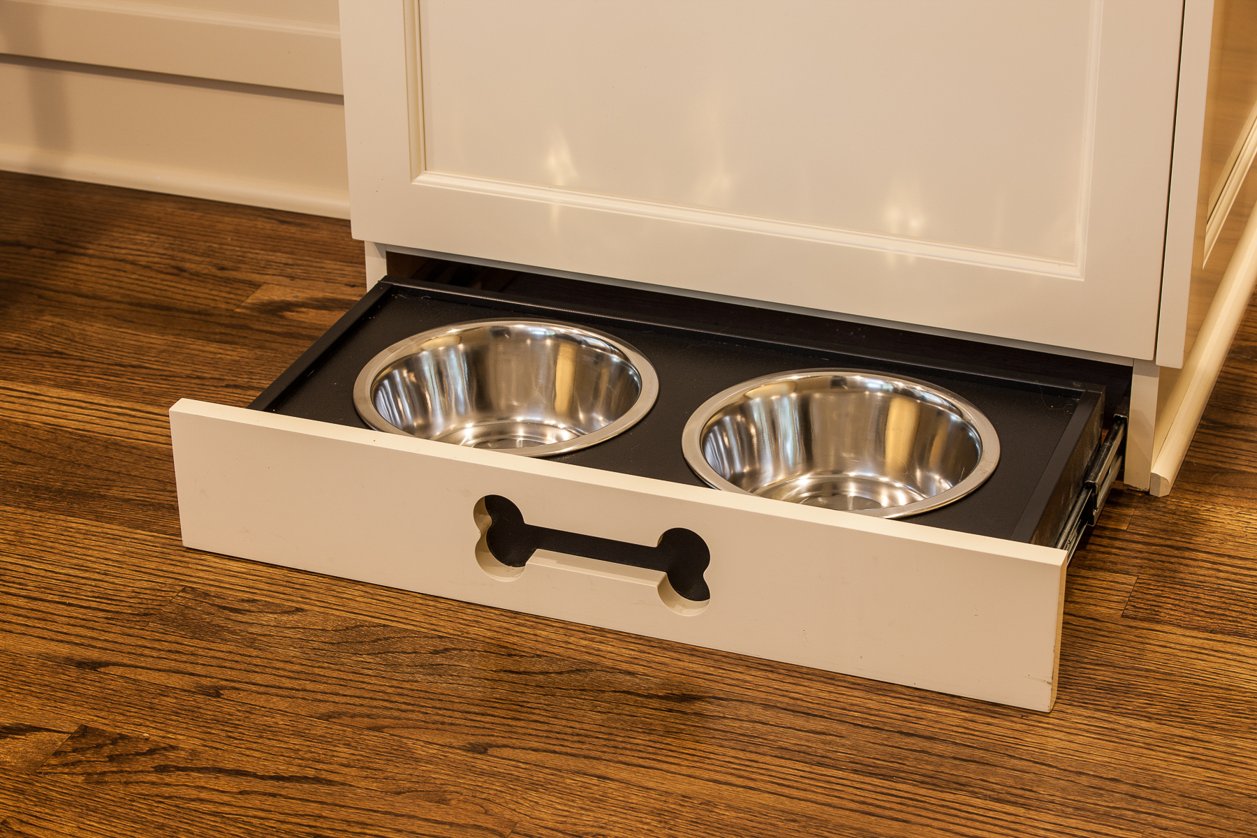 Remodeled kitchen with pull-out dog bowl drawer added under cabinet