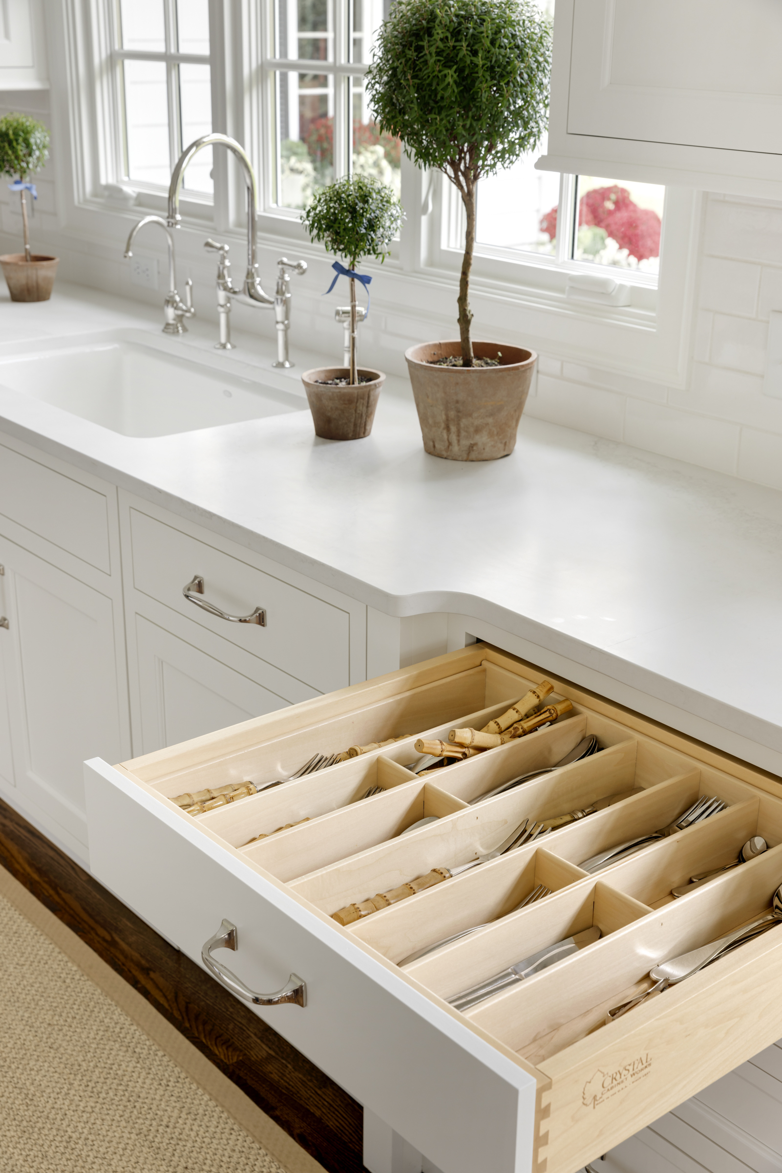 Drawer with silverware storage in kitchen remodel with white cabinets