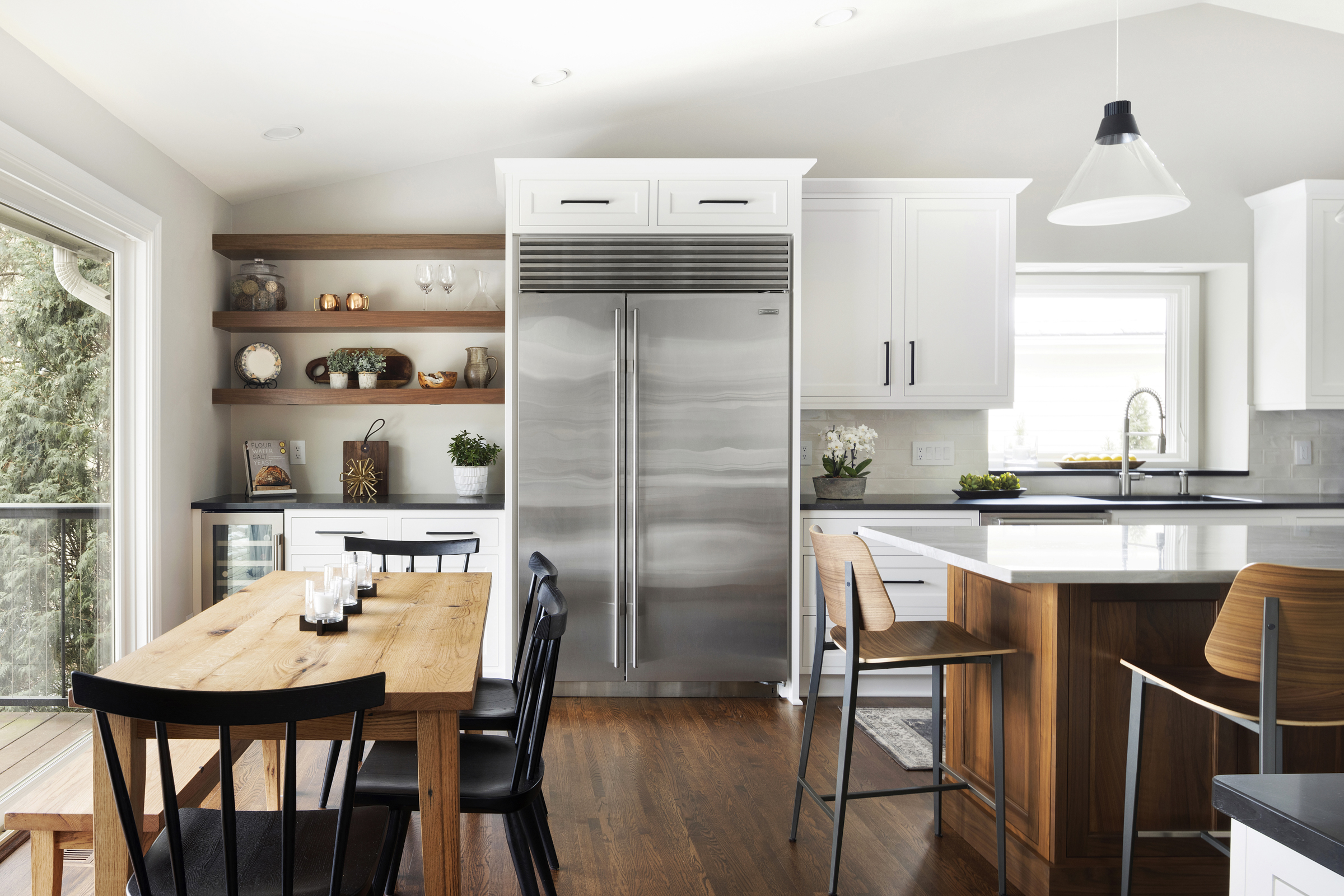 Kitchen with wood tones and white kitchen with stainless steel refrigerator