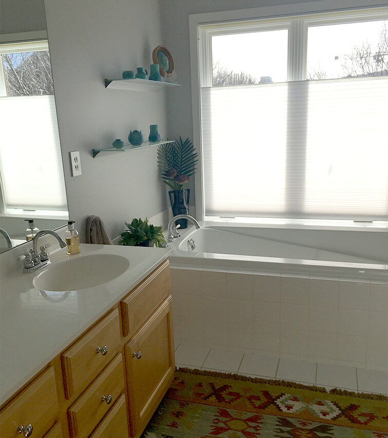 Bathroom before remodel with built in tub and large window