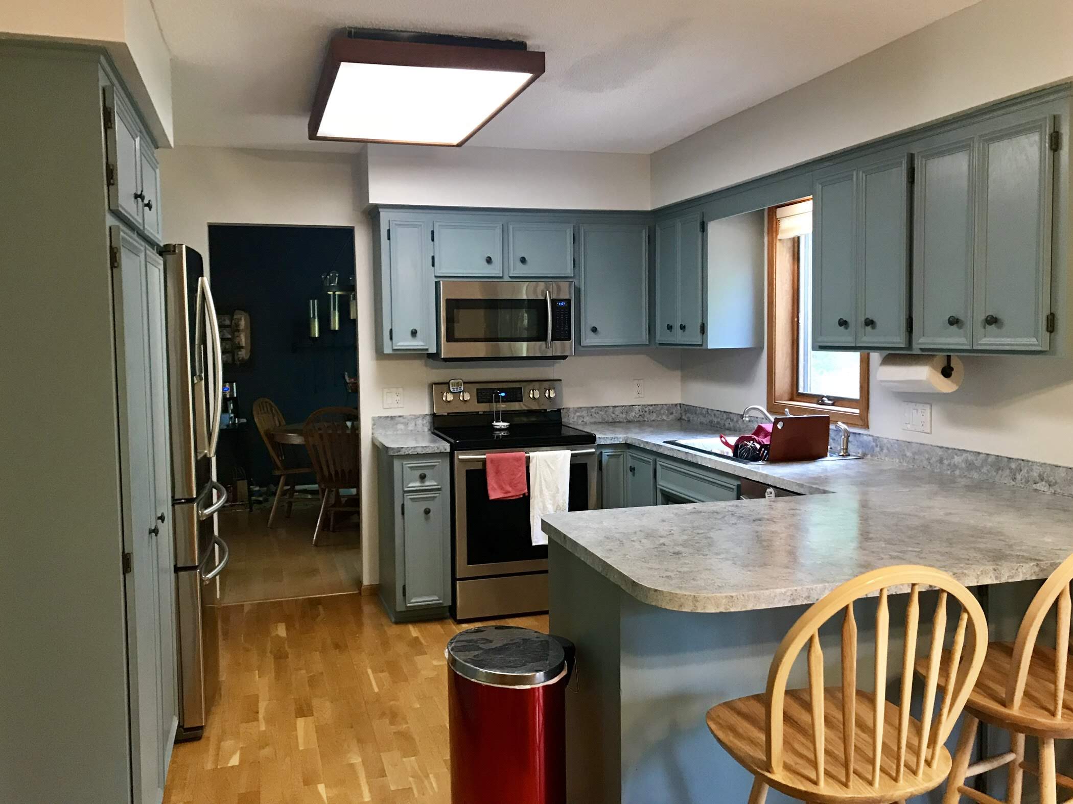 Kitchen before remodel with dark cabinets and outdated fixtures