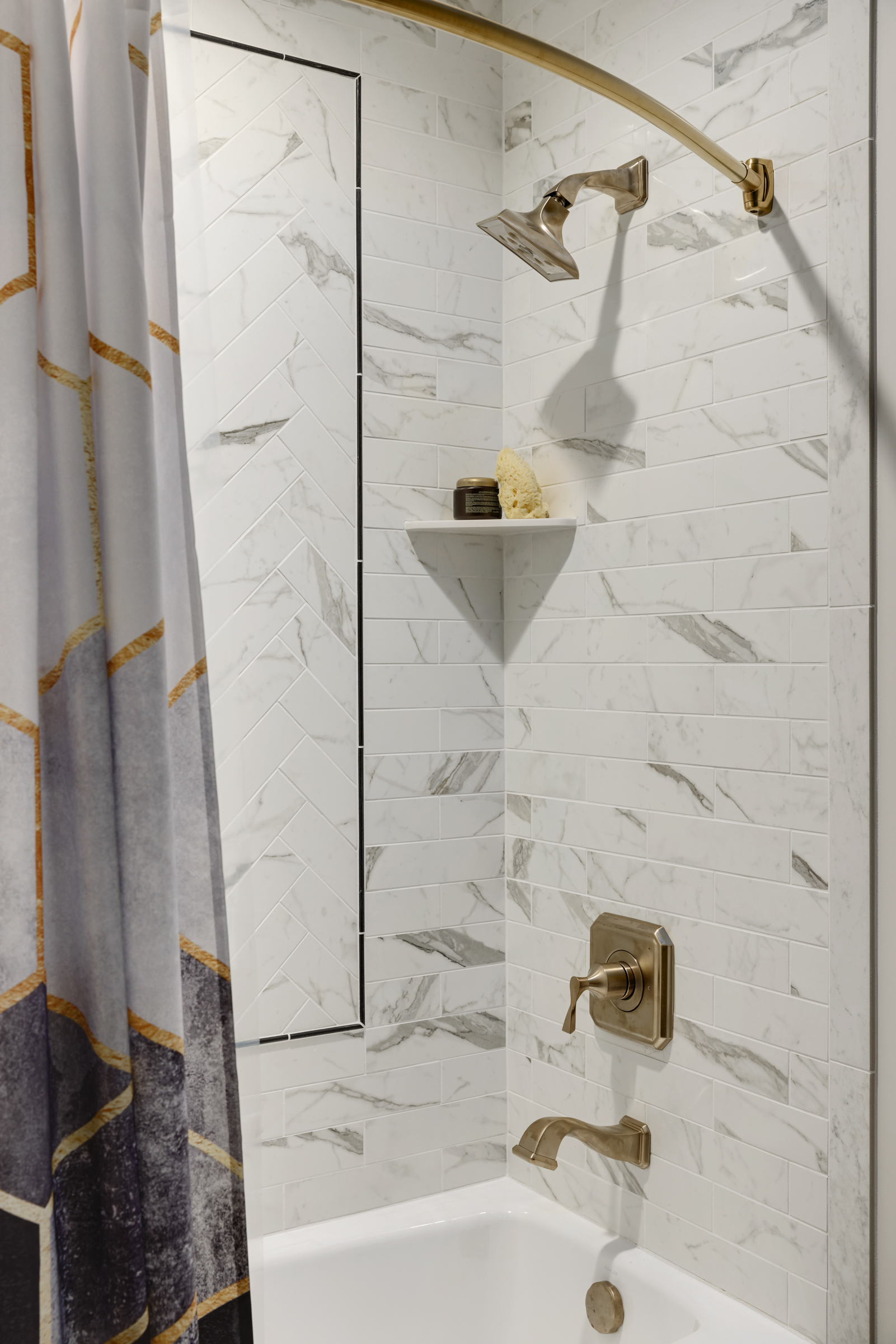 Guest Bathroom remodel with dark hexagon floor tile, wooden vanity, and gold fixtures