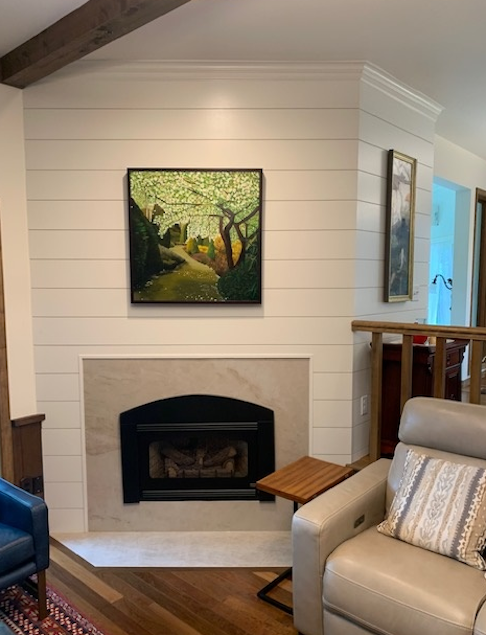 Remodeled fireplace with white shiplap and tile surround