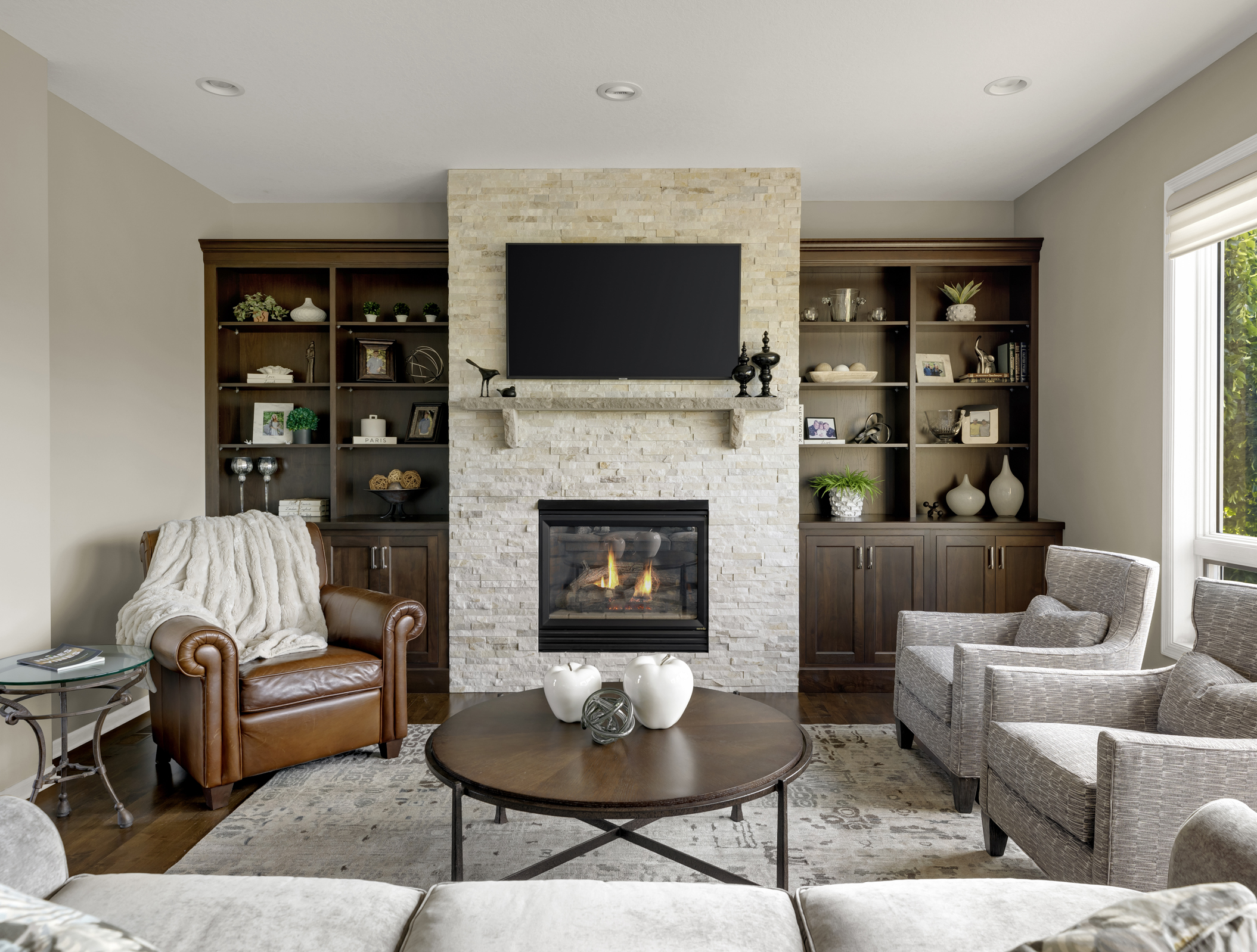 Fireplace remodel with dark wood built ins and stone