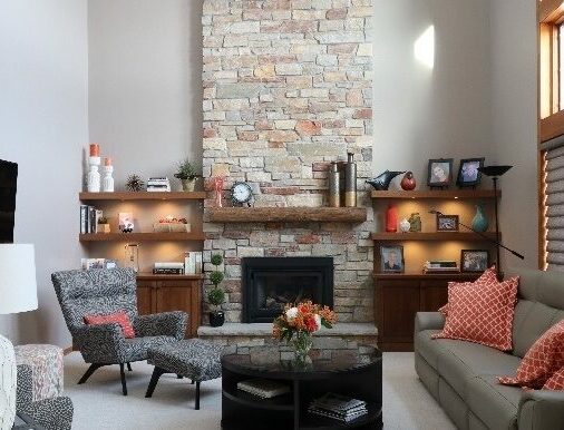 Fireplace remodel with dark wood built ins and stone