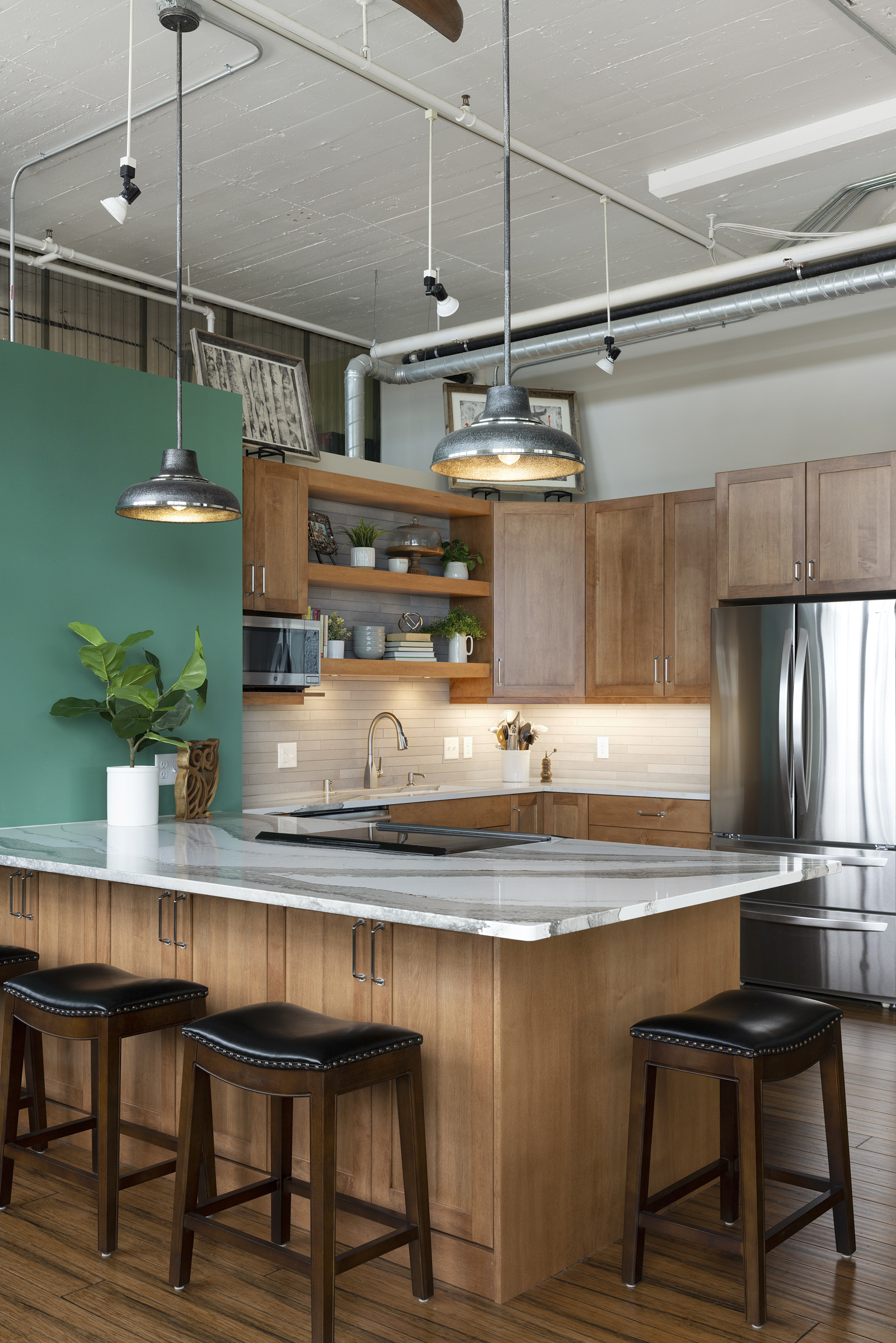 Artistic kitchen renovation with wood cabinets and green accent wall