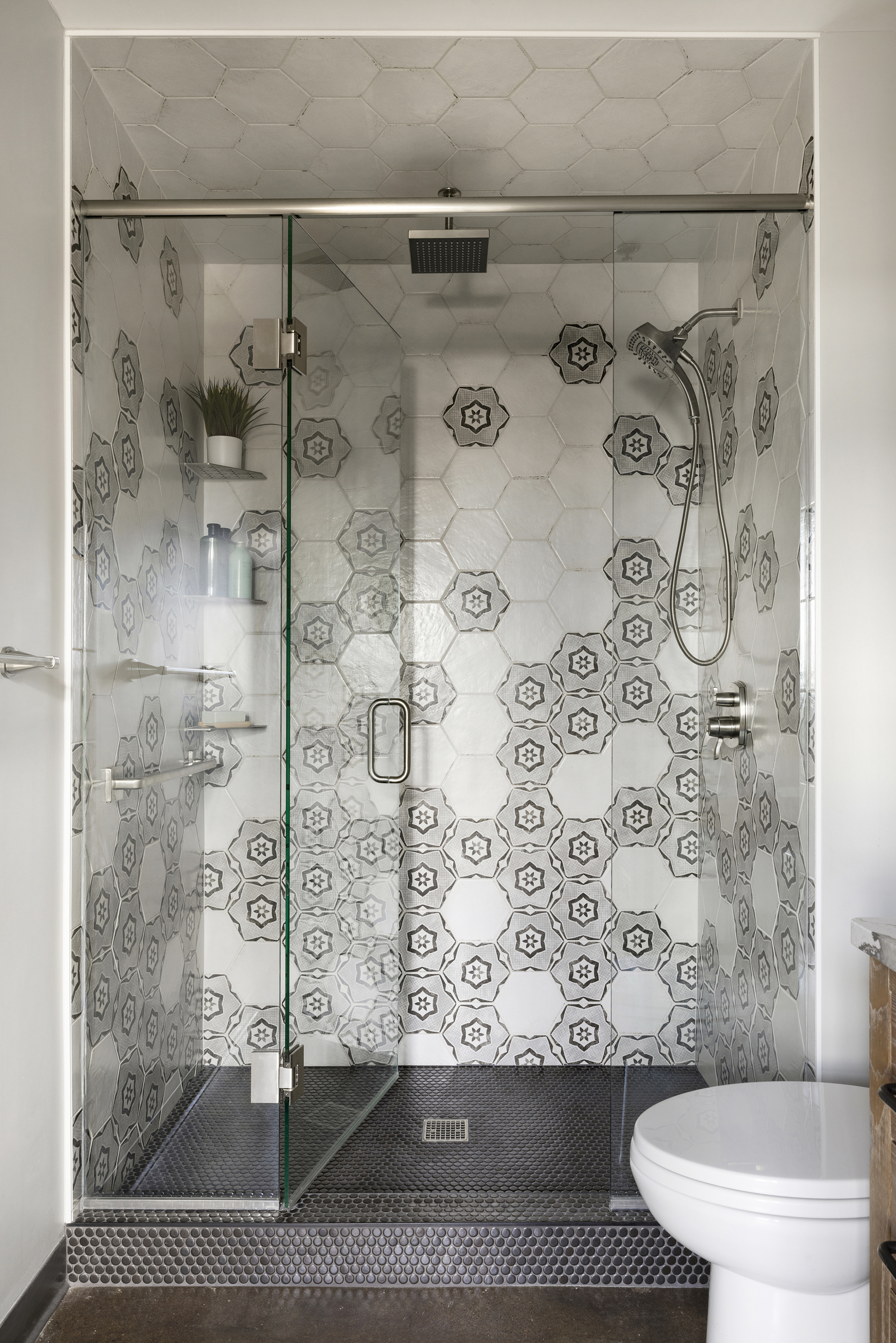 Bathroom renovation with hexagon shower tile and glass enclosure