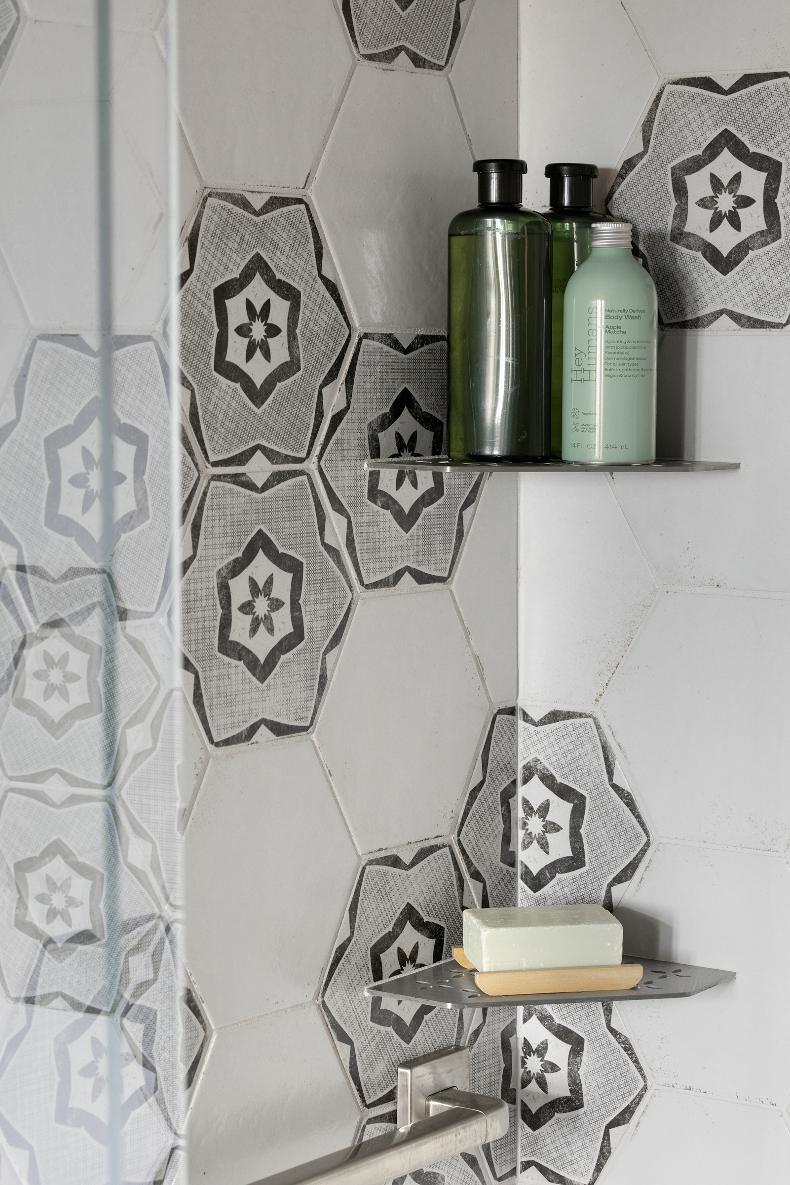 Bathroom renovation with hexagon shower tile and built in shelving