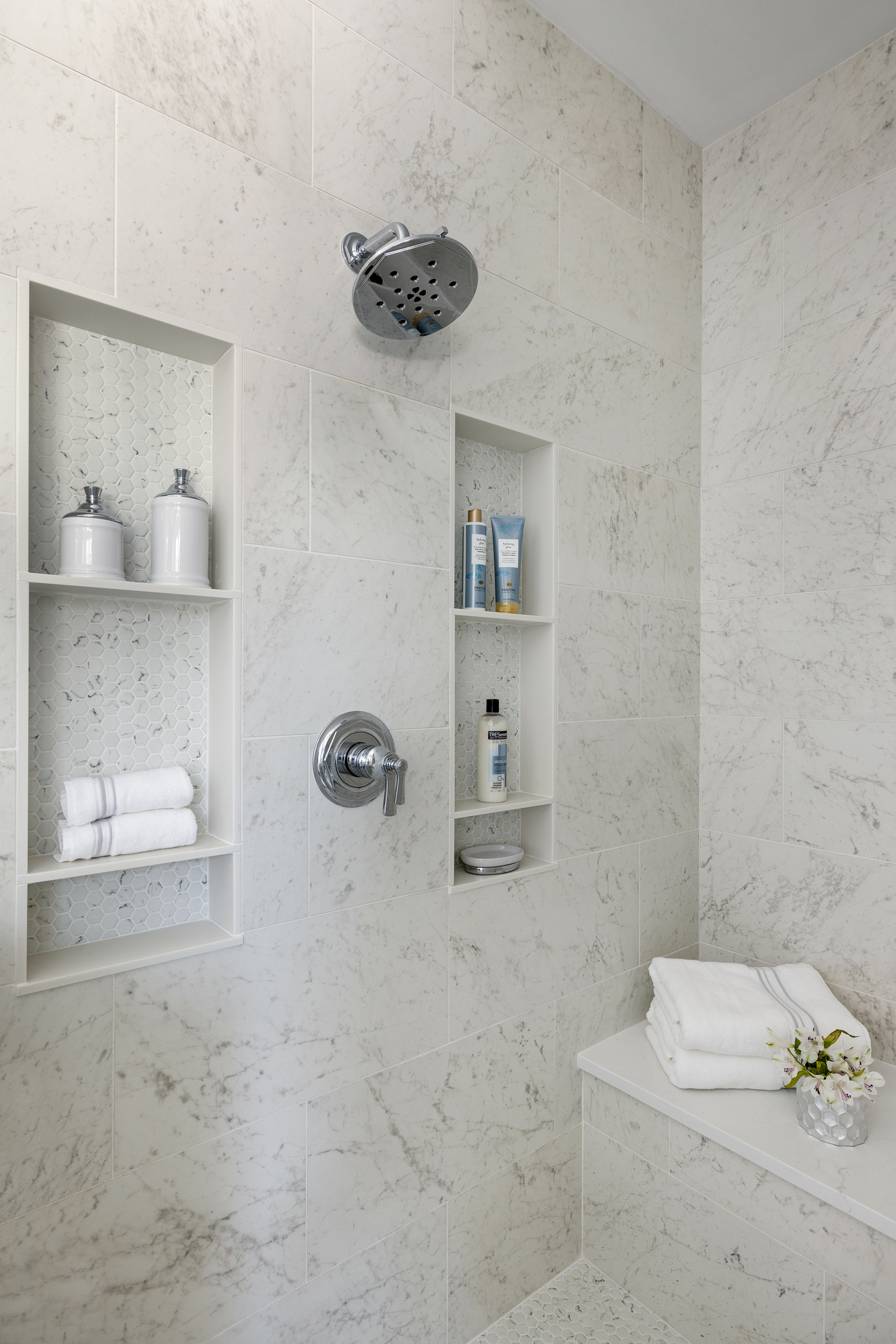 European inspired bathroom remodel with light blue vanity and white tile floor