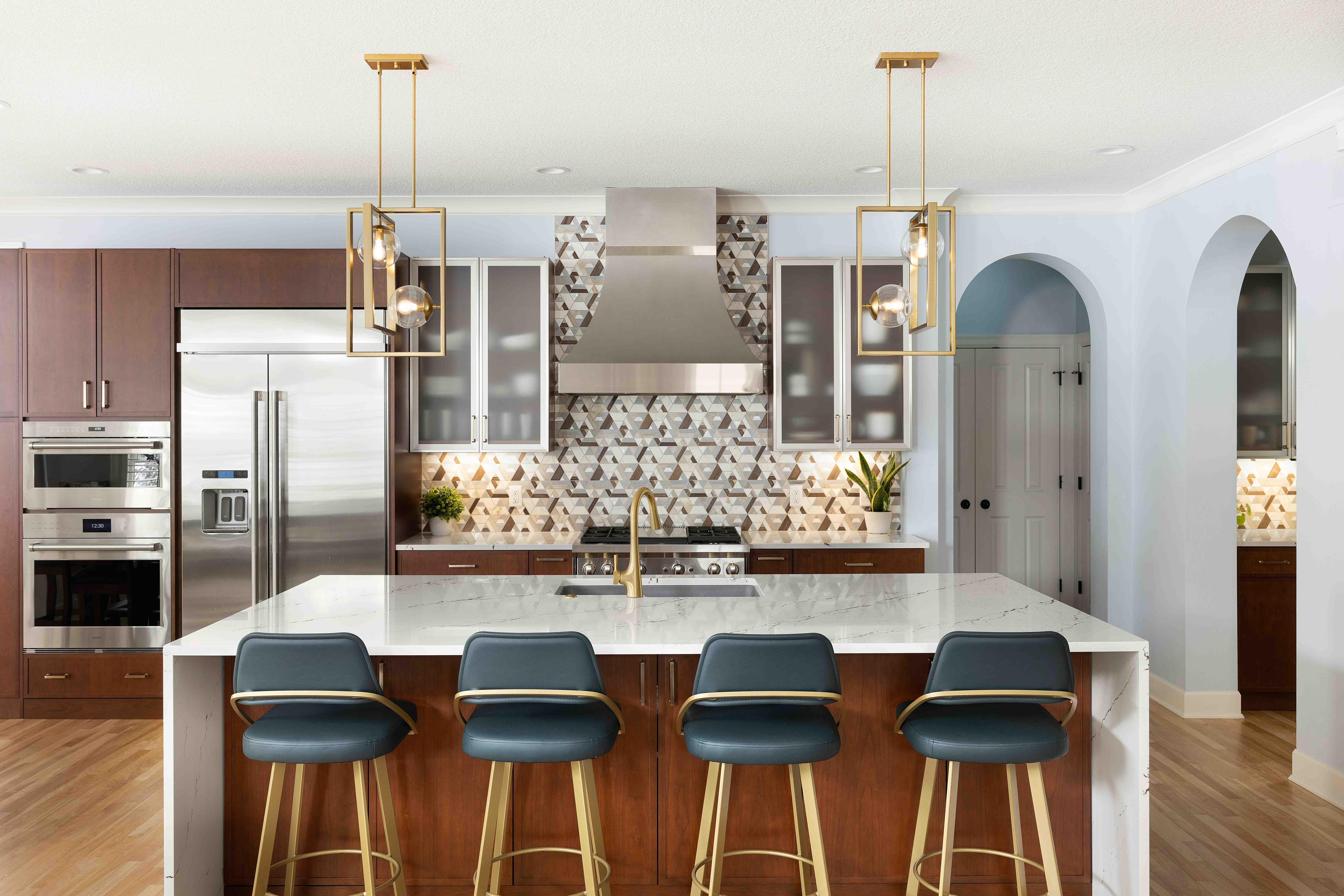 Kitchen remodel with mixed metals, large island with pendant lights