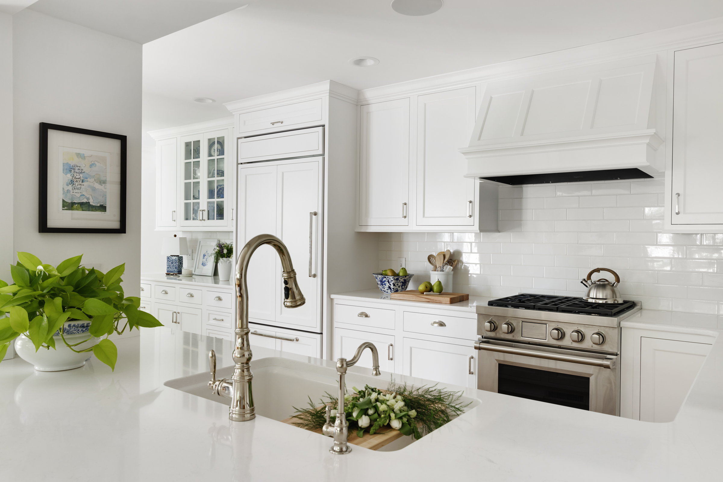 Twin Cities kitchen remodel with white cabinets, wood floor, and natural light