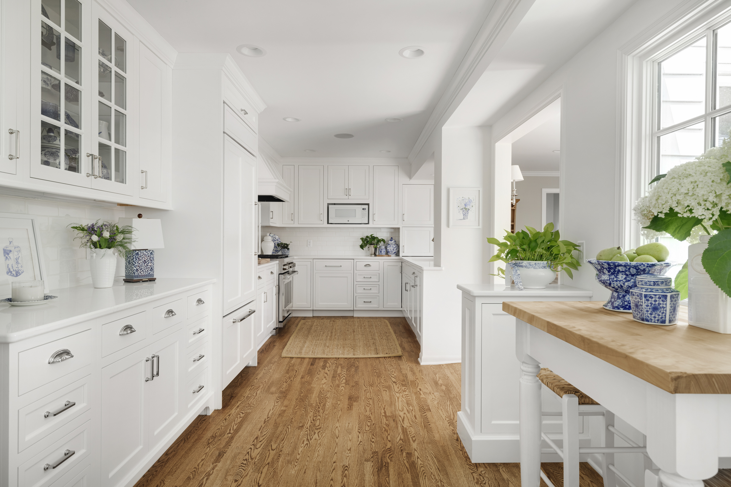 Twin Cities kitchen remodel with white cabinets, wood floor, and natural light