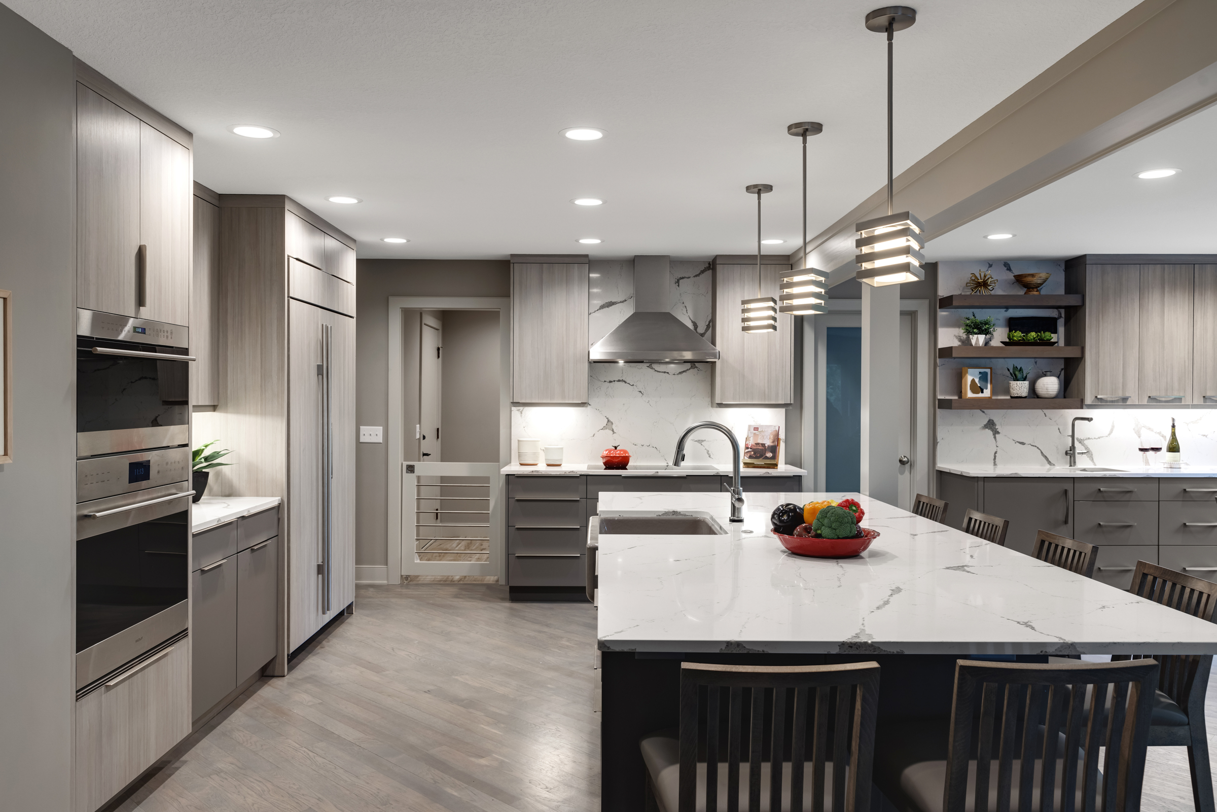 Contemporary kitchen addition with dark island, light floors, and updated appliances