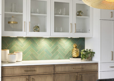 Dining room remodel with two toned cabinets and green tile backsplash