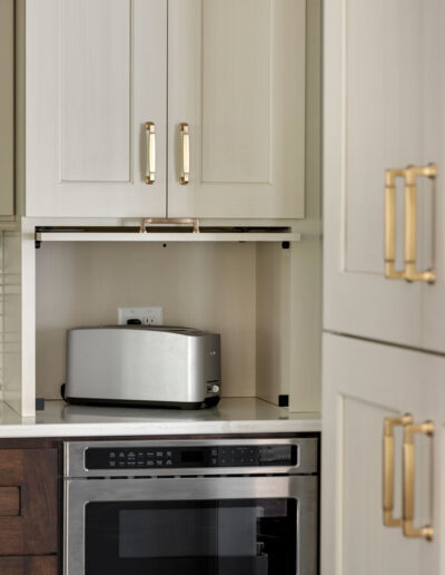 Drawer microwave with a pocket door appliance garage above for multiple small appliances.