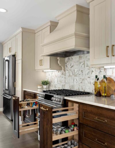 Custom pull-out spice and organization cabinets in luxury kitchen remodel.